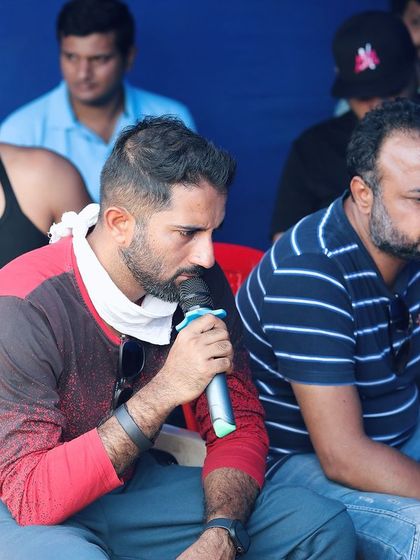 Watching the monitor during a take. As a stunt director, I'm not just looking at the performance but also at the camera angles and timing to make sure the hits sell and the story is clear.