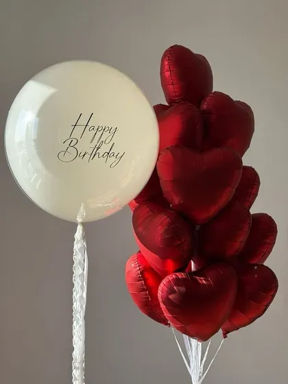 A classic combination of red and off-white for a birthday surprise. This bunch includes a personalized "Happy Birthday" balloon paired with a bouquet of red foil hearts.