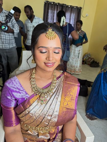 A beautiful shot of my bride Swathy during her engagement. The makeup is subtle and glowing, with a soft pink eyeshadow and a natural lip, perfectly complementing her purple and silver saree.