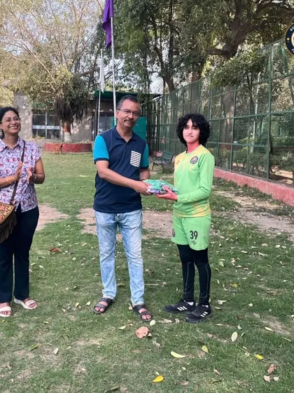 Our goalkeeper receiving her new kit from our well-wishers. This support from our community is what keeps us going.