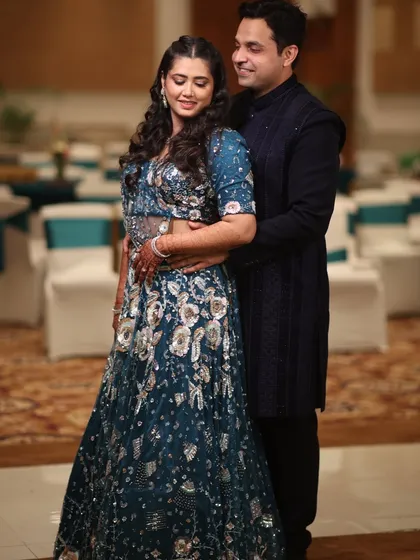 The couple posing for a photo, their coordinated outfits in shades of blue perfectly matching the elegant theme of the evening.