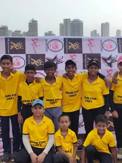 The Inningstar Lions junior team posing for a photo in front of the event banner.