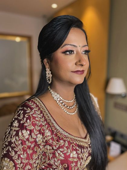 A side profile of the bride, her makeup looking flawless and her expression confident.