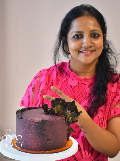 Another beautiful example of a student's work, this ganache cake features a unique textured finish and abstract chocolate shards.