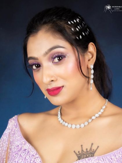 A close-up portrait from the lilac lehenga shoot. You can clearly see the lilac glitter liner and the flawless, dewy skin, a signature style of mine that ensures you glow on camera.