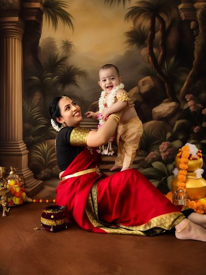 A playful and dynamic shot of a mother and her laughing baby in a forest-themed setting. The genuine joy in this photo is contagious.