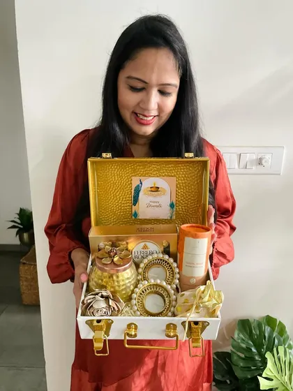 Here I am holding one of the luxurious white and gold metal trunks. It's a substantial and impressive gift, perfect for making a statement this Diwali.