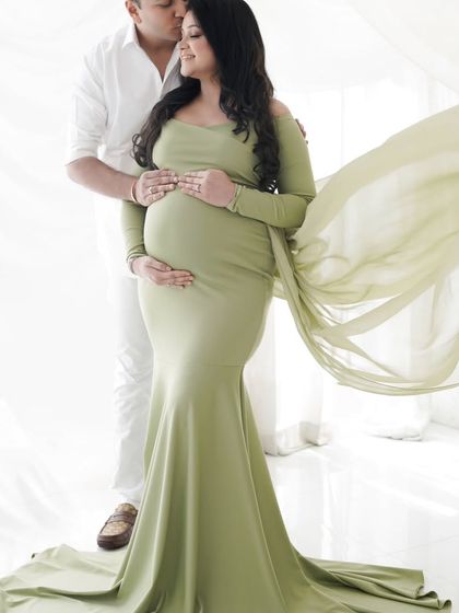 An intimate portrait of an expecting couple. The way he holds her close shows the love and support that surrounds their growing family.