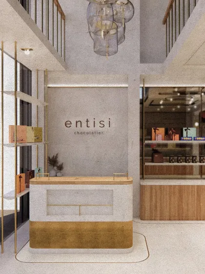 A render of the Entisi reception area, showcasing the interplay of light and texture. The design uses a double-height space, minimalist branding, and a custom chandelier to create a grand yet welcoming entrance.