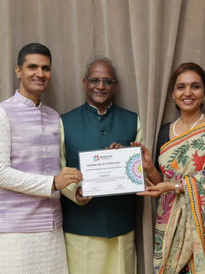 A senior student receiving his certificate, proving that the path of a yoga seeker is lifelong and age is no barrier.
