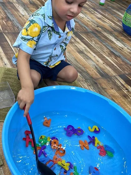 Another little one enjoying the letter fishing game. It's a great activity for improving hand-eye coordination and early literacy skills.