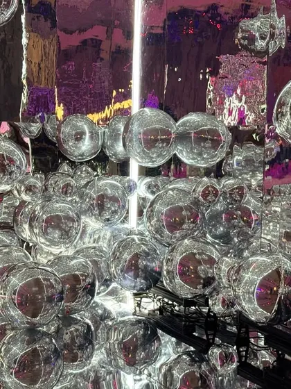 A close-up of the silver bubble installation. This walkway was designed to create a feeling of being in a world of funk and visual magic from the moment guests arrived.