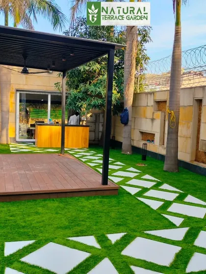 This angle shows the full scope of the Dwarka front yard, with the pergola, bar area, and pathway creating a cohesive and inviting space.