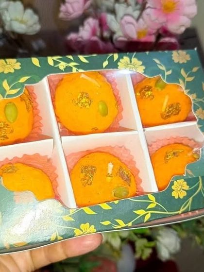 A close-up of the green floral 6-cavity box filled with Ladoo candles. The design is elegant and perfect for festive gifting.