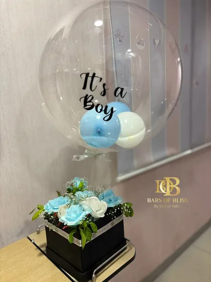 A chic and simple "It's a Boy" announcement gift, combining a box of fresh blue and white flowers with a custom balloon.