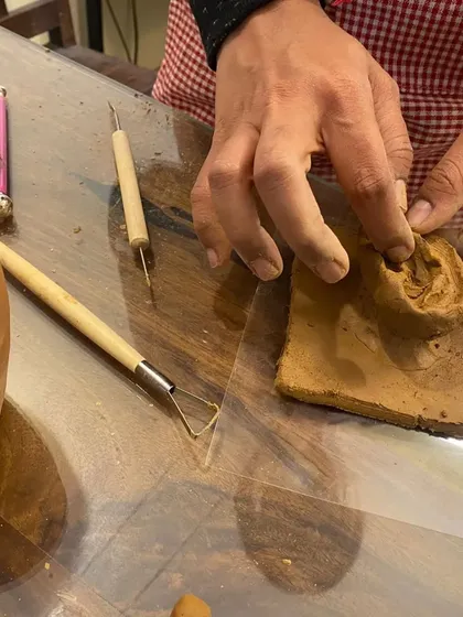 Getting hands-on with clay in our ear sculpting workshop. This close-up shows the tactile process of shaping and forming the clay, a fundamental skill in pottery and hand-building that is both meditative and rewarding.