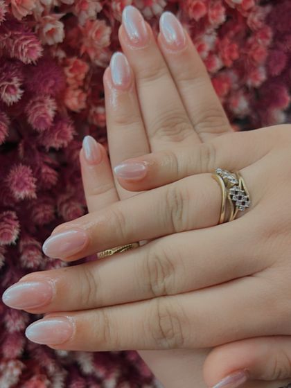 A beautiful example of a "baby boomer" or French ombré nail, where the white tip softly fades into the pink base. The pearly finish gives it an extra glow.