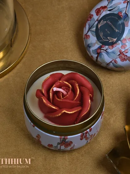 A deep red rose with gold accents in a festive tin, perfect for Diwali or Christmas gifting.