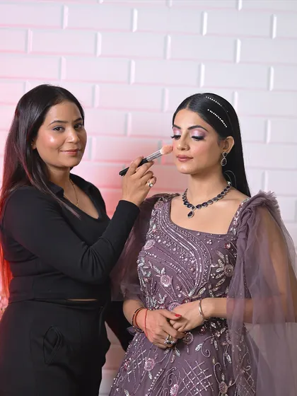 Another one of our talented students perfecting a soft glam look. Notice the focus on blending the eyeshadow seamlessly, a core technique we emphasize in our makeup courses.