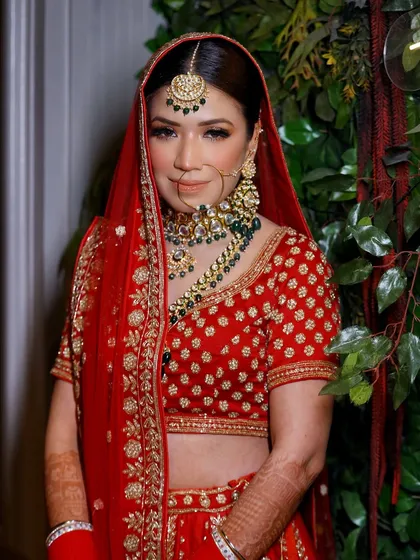 A classic bridal portrait. The bride looks directly at the camera, exuding confidence and happiness on her special day.