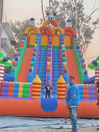 A straight-on shot of the 4-lane slide, showing the climbing net in the middle and the character details at the top.