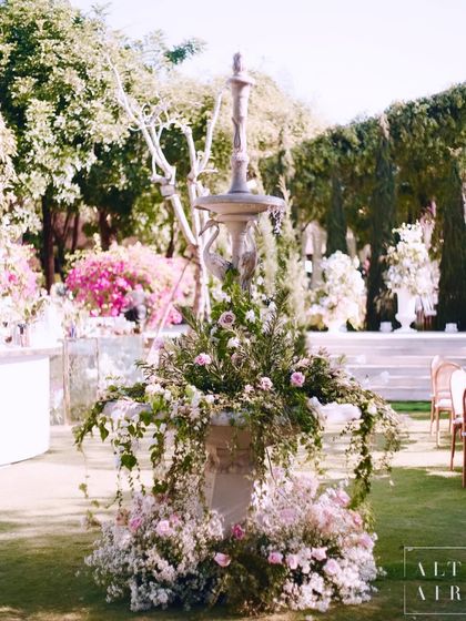 A beautiful floral installation on a stone fountain at our Bali wedding. In the details lies the true depth of designing.