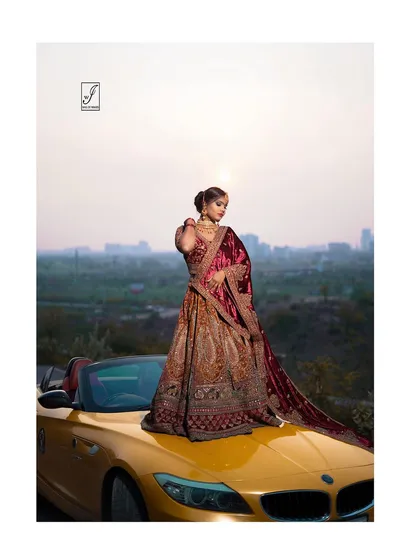 A closer view focusing on the detailed craftsmanship of the lehenga and the model's poised expression against the setting sun.