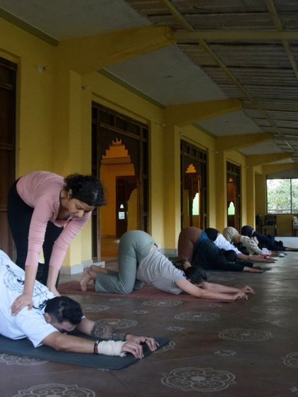 Here I am offering a gentle adjustment in child's pose. My goal is always to help students feel more comfortable and supported, allowing them to relax more deeply into the posture.