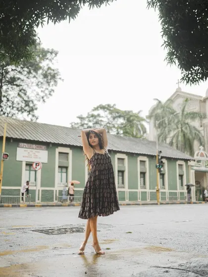 An on-location shoot with Niyati Fatnani on the streets of Bandra, Mumbai. This wide shot uses the urban environment and a church in the background to create a sense of place.