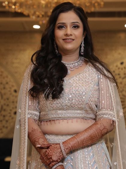 A full-length shot of this gorgeous engagement lehenga and the soft, glowing makeup we paired with it. The overall look is one of pure elegance and celebration.