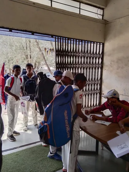 The registration desk buzzing with activity as young players line up for the trials. The dream begins here.