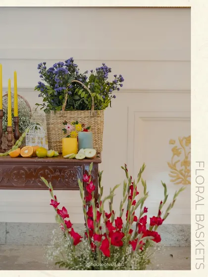 A detail shot of a floral basket and citrus fruits on a console table, adding to the rustic and authentic Italian market feel.