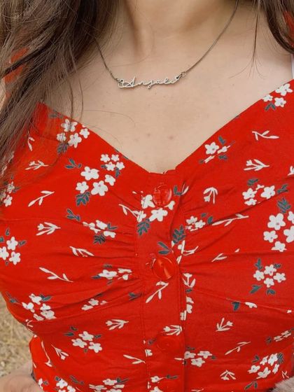 A custom name necklace in a silver finish, offering a cool-toned alternative to classic gold. This piece demonstrates the versatility of the script style in different materials.