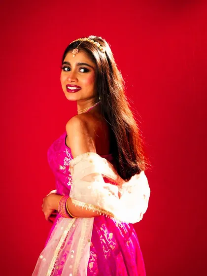 A playful, over-the-shoulder smile that captures a sweet and charming personality.
