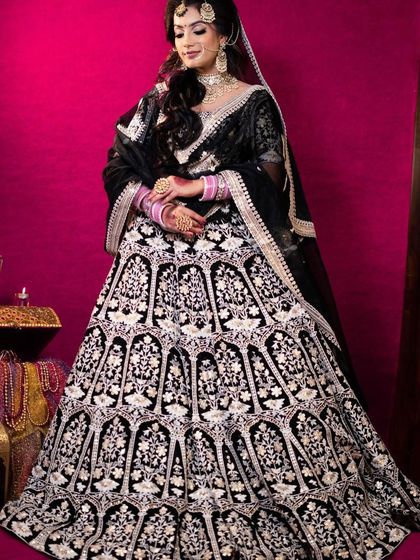 The full view of the black velvet lehenga, showing its grand flare and the beautiful contrast of the silver embroidery.