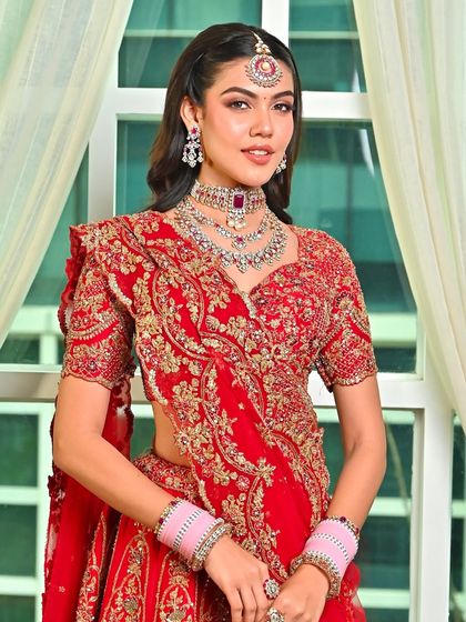 Draped in timeless red, this bridal look is all about luminous skin and soft sculpting. It’s a celebration of heritage, beauty, and that just-married glow.