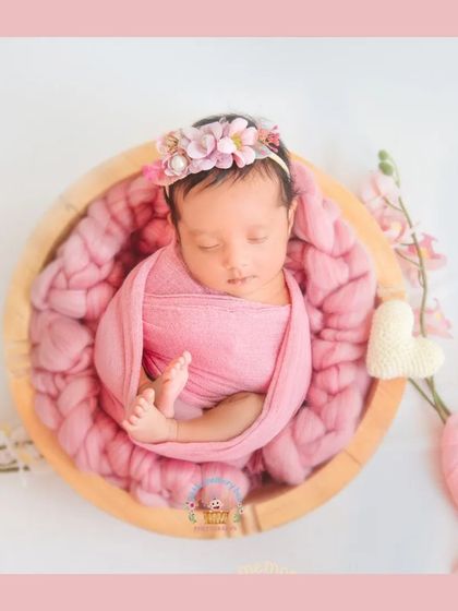 A slightly different composition of the pink bowl setup, with floral accents and a fabric bow to complete the look. It's all about creating a beautiful, cohesive image.