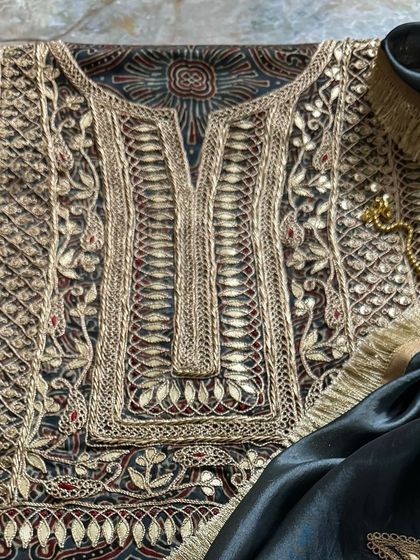 A detailed close-up of the kurta's neckline, where the intricate Gota Patti and Marodi hand embroidery creates a stunning tapestry of texture and shimmer.