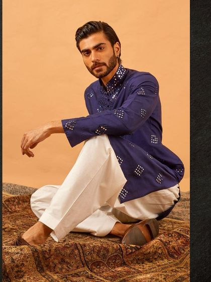 The full look of our blue mirror work kurta, paired with classic white trousers. It's a comfortable and stylish choice for any festive gathering, day or night.