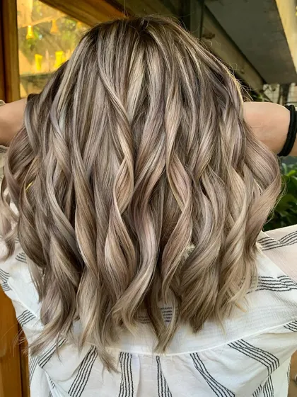 The back of this blonde bombshell look. The highlights are perfectly placed for a bright, all-over blonde effect.