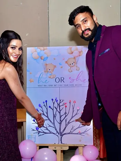 A unique gender reveal activity for the guests. The couple adds their fingerprints to a tree, casting their vote for 'he or she' on a custom-designed board.