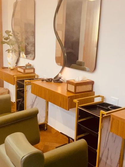 Our styling stations are designed for comfort and function, with clean lines, natural wood, and elegant marble accents.