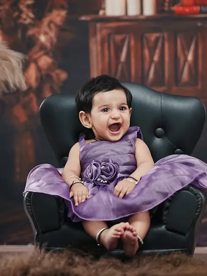 A big, happy laugh from our six-month-old, sitting like a little queen in her miniature armchair.