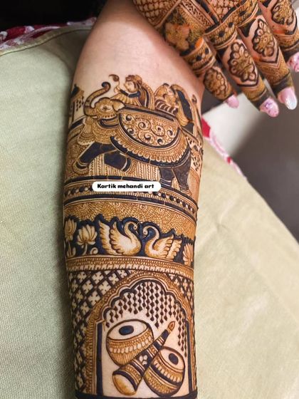 This forearm design showcases a majestic elephant procession and a pair of graceful swans. These classic motifs bring a sense of royalty and elegance to the mehandi.