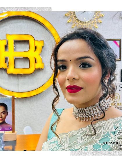 A beautiful party look with soft, curly hair and a classic red lip. This client is ready to shine at her event.