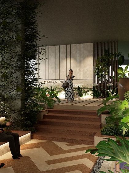 The clubhouse entrance at Marian Park, located in the basement, is designed to feel grand and inviting. Tiered seating, rich wooden steps, and an abundance of tropical plants create a warm and sophisticated transition from the outdoors.
