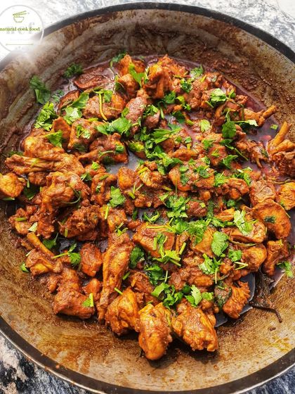A large wok of my chicken curry, enough for 26 people, garnished with plenty of fresh coriander.