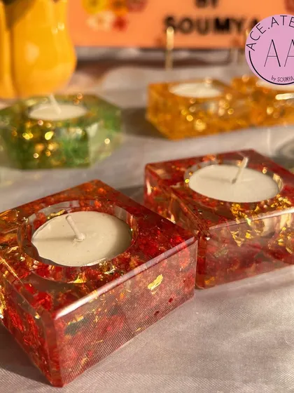 A collection of my resin t-light holders in various shapes and colors. The red and gold set in the foreground is particularly popular for festive and wedding decor.