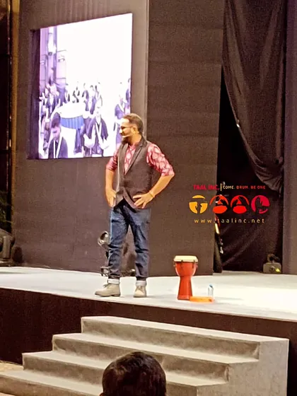 A confident smile from our facilitator on stage. The ability to connect with an audience, even in a formal setting, is a skill we nurture in our training programs.