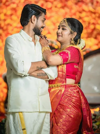 A playful and romantic moment between the couple. The bride's makeup looks stunning, even in a candid shot.